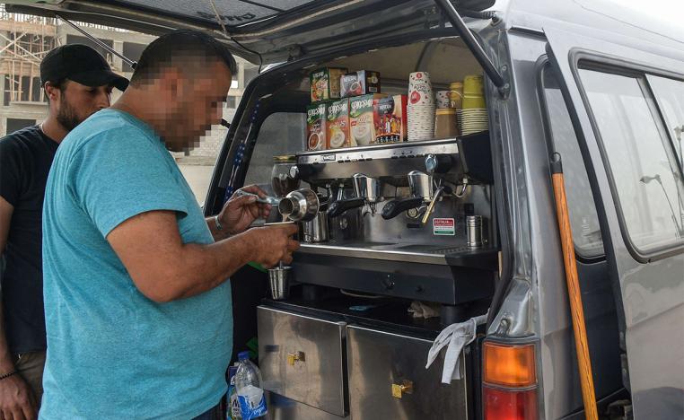 A Syrian refugee prepares coffee at the back of an improvised food truck in the Egyptian capital Cairo 