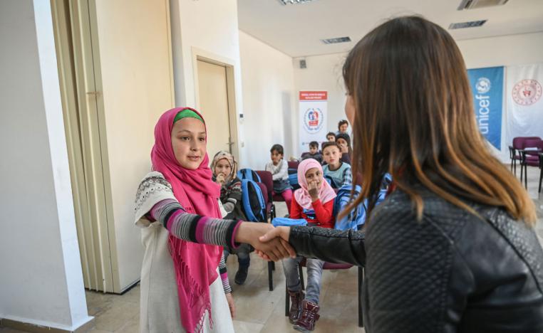 A teacher gives Turkish language lessons to Syrian children at Turkish Youth and Sport Center (Genclik ve Spor Merkezi) in Adana on March 18, 2019.