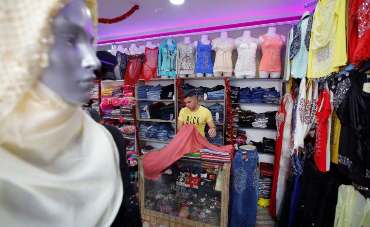 Syrian shopkeeper Mustafa is pictured at his clothes shop in Istanbul's Kucukcekmece district