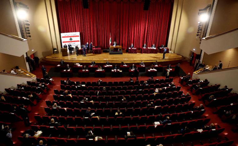 Lebanese members of Parliament attend a legislative session in a theatre hall