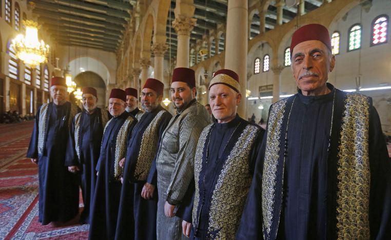Muezzins, who call Muslims to prayer, pose for a picture at the Umayyad Mosque in the ancient quarters of Damascus