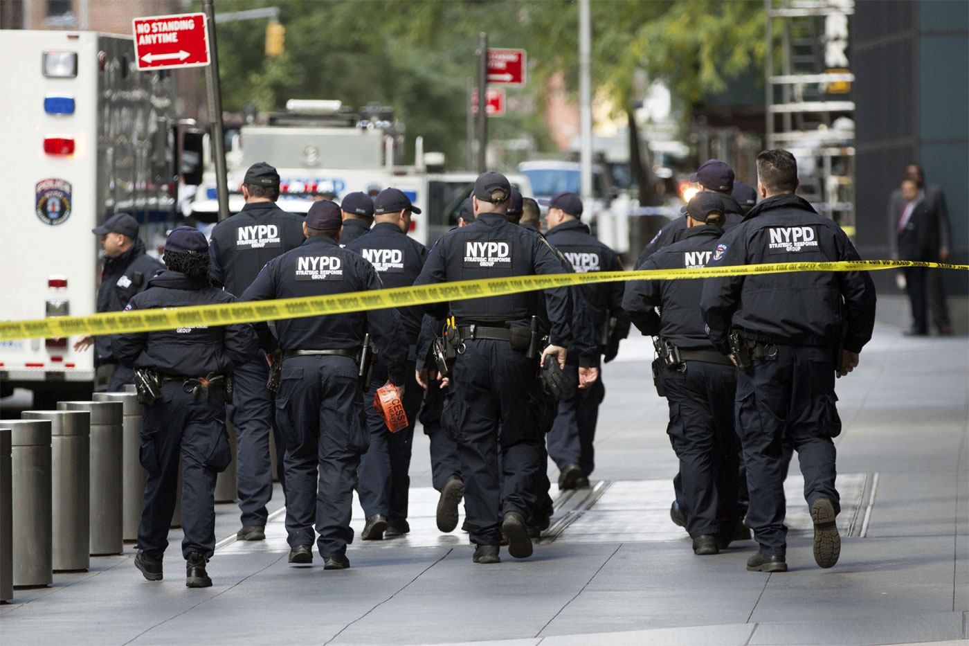 Officers inspect the scene outside the Time Warner Center 