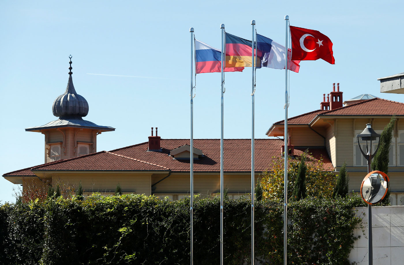 Flags of Russia, Germany, France and Turkey flutter in front of the presidential Vahdettin Mansion prior to a summit on Syria, in Istanbul, Turkey October 27, 2018. 