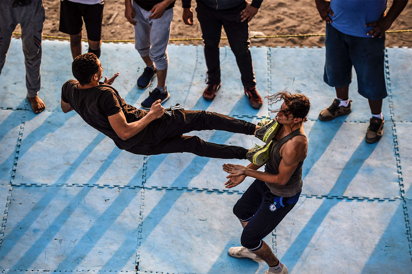 Members of the self-declared Egyptian Wrestling Federation (EWR) train in a ring during a session in the village of Serapeum