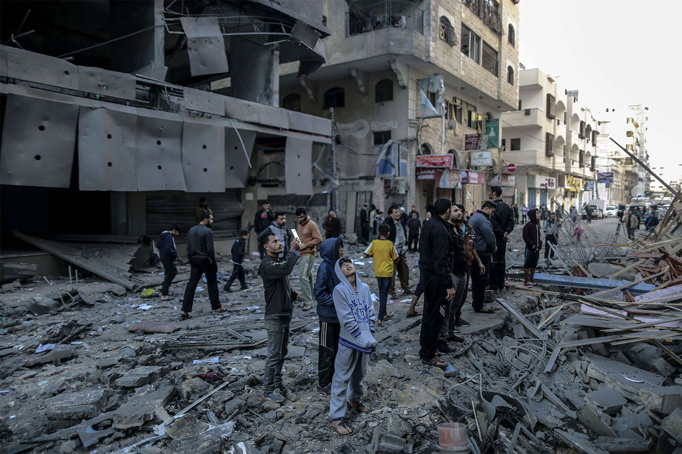 Palestinians inspect the damage of a destroyed residential building in Gaza after hitting by Israeli air strikes 