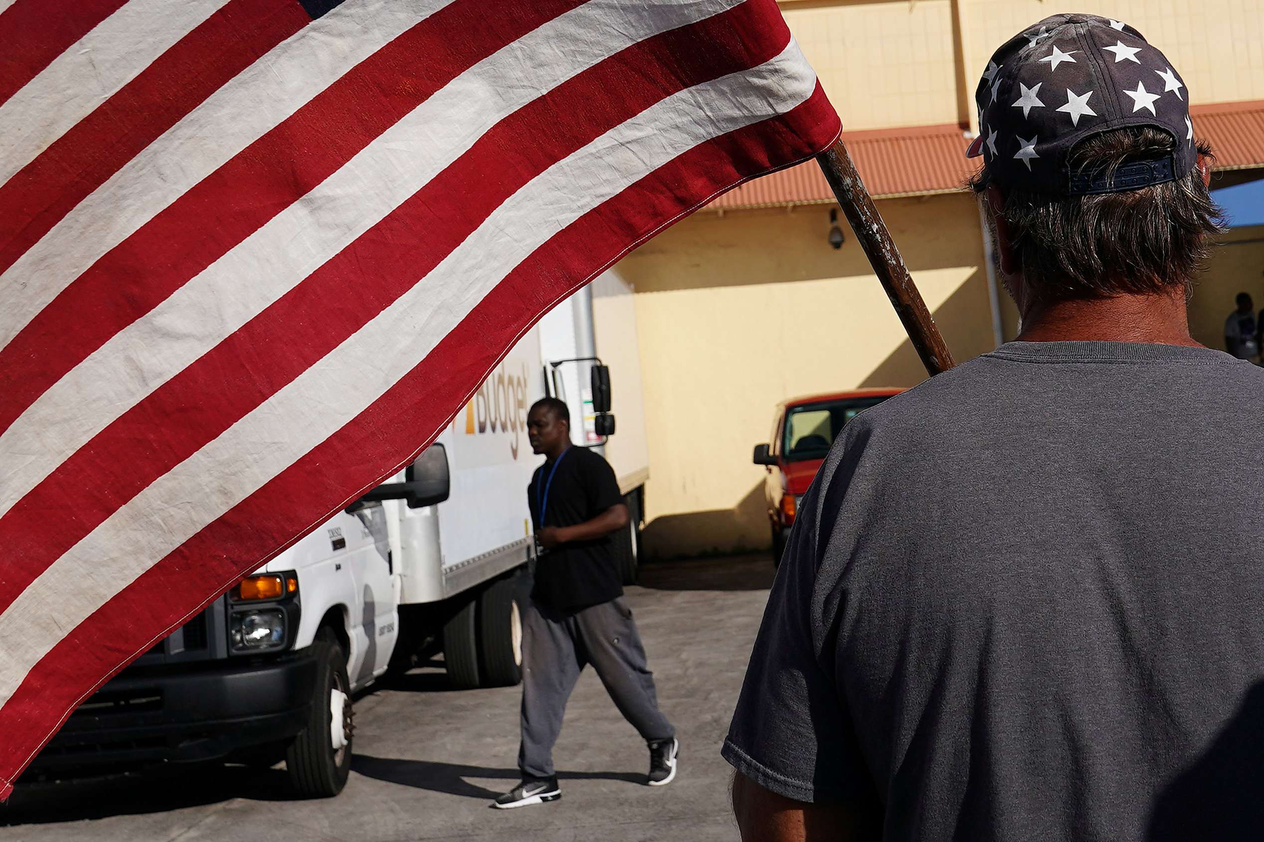 A man holding a flag insults verbally another man outside Broward County election offices during a ballot recount in Lauderhill, Florida, US on November 12, 2018.