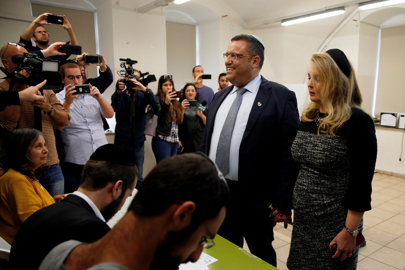 Jerusalem mayoral candidate Moshe Lion and his wife arrive to cast their votes.