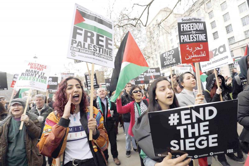 Protesters in central London shout slogans and hold placards during a demonstration in support of Palestinians, last April 7
