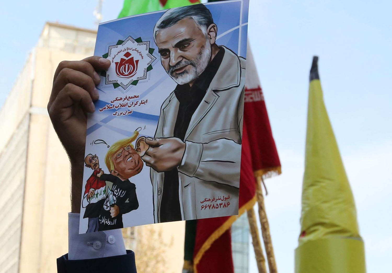 متظاهر يرفع صورة لقاسم سليماني قائد فيلق القدس الإيراني المسؤول عن الميليشيات الشيعية في المنطقة