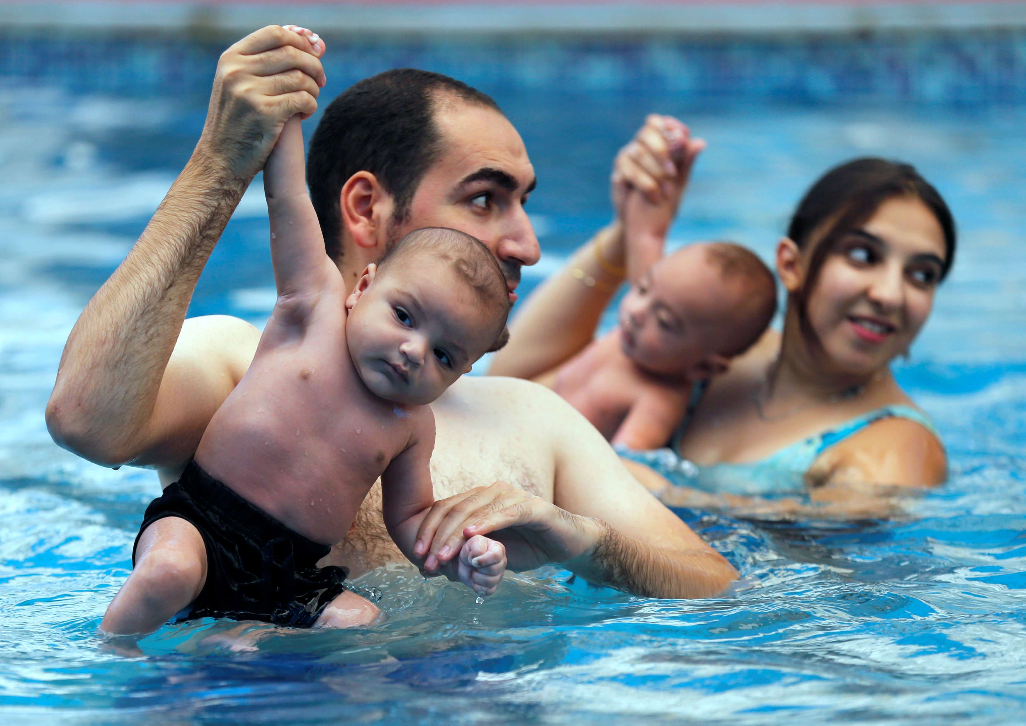 Egyptian parents teach newborns how to swim in Cairo