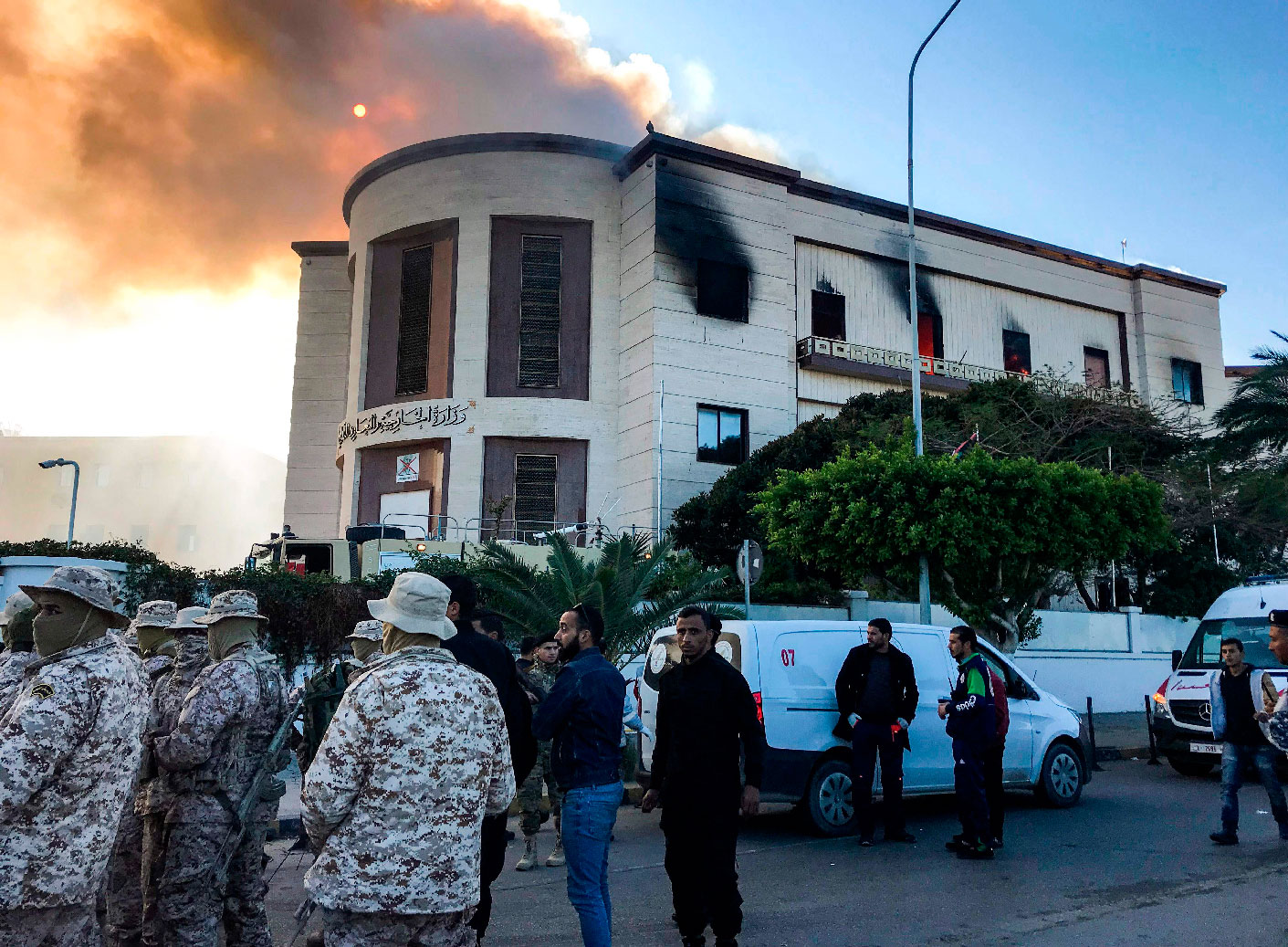 A picture taken on December 25, 2018 shows paramedics and security officers at the scene of an attack outside the Libyan foreign ministry headquarters in the capital Tripoli.