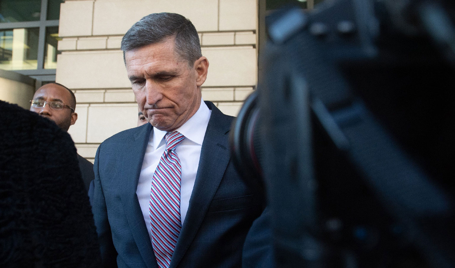 Former US national security adviser Michael Flynn passes by members of the media at US District Court in Washington, on December 18. 