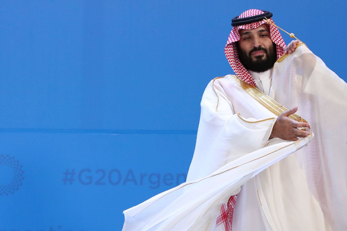 Saudi Arabia's Crown Prince Mohammed bin Salman adjusts his robe as leaders gather for the group at the G20 Leader's Summit at the Costa Salguero Center in Buenos Aires, Argentina, Friday, Nov. 30, 2018.