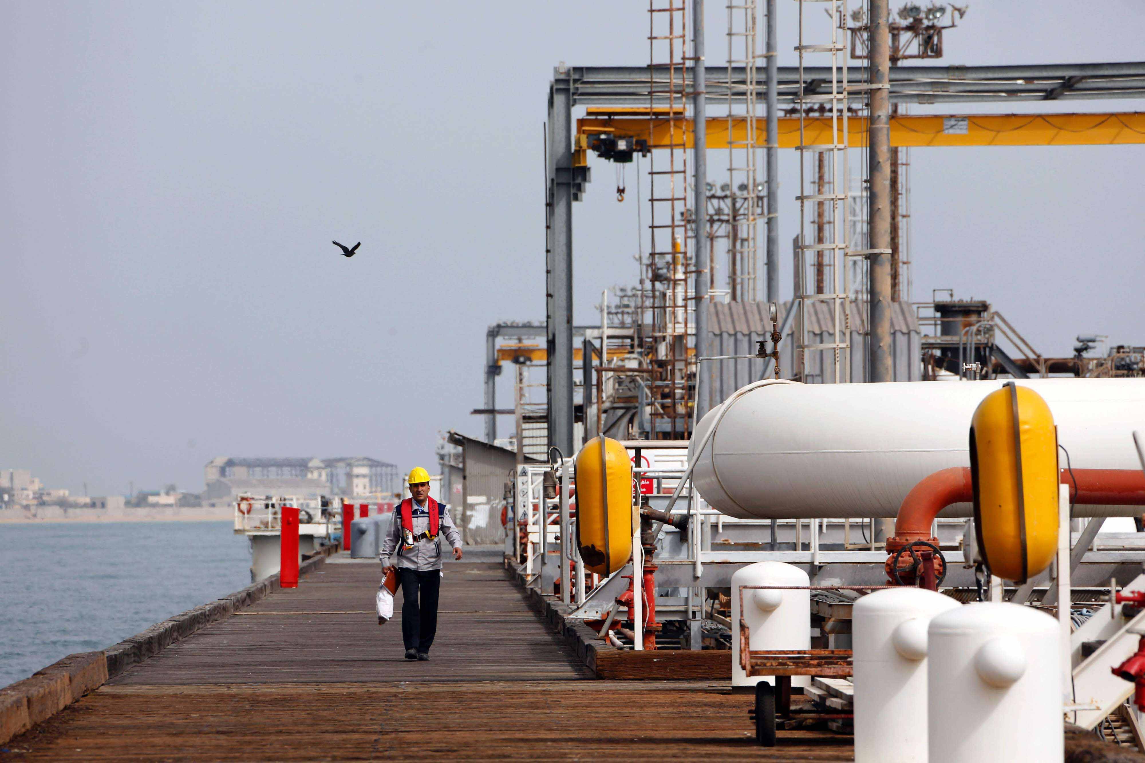 An Iranian worker walks the platform of an oil facility in the Khark Island. 