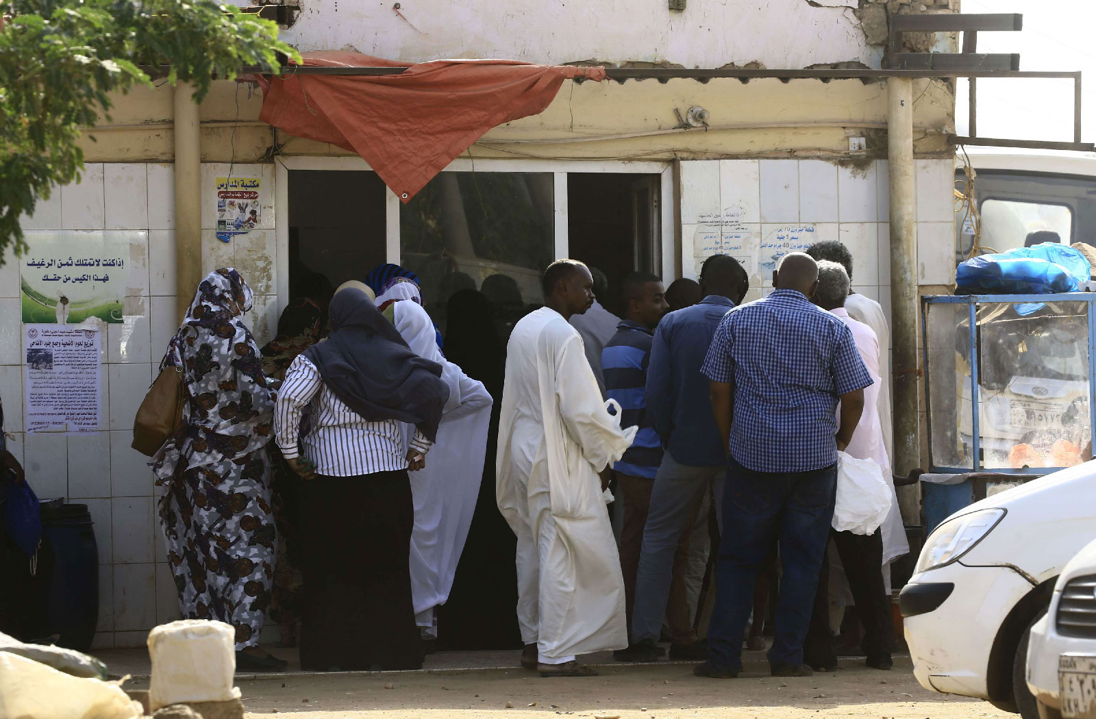 People queue in front of a bakery in the Sudanese capital Khartoum on August 26, 2018.
