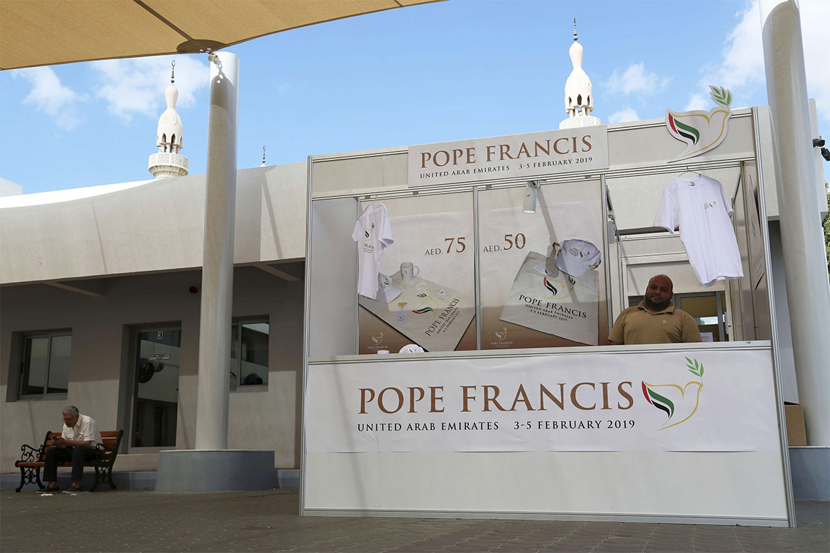 A man sells memorabilia for Pope Francis' upcoming trip to the UAE at St. Mary's Catholic Church in Dubai