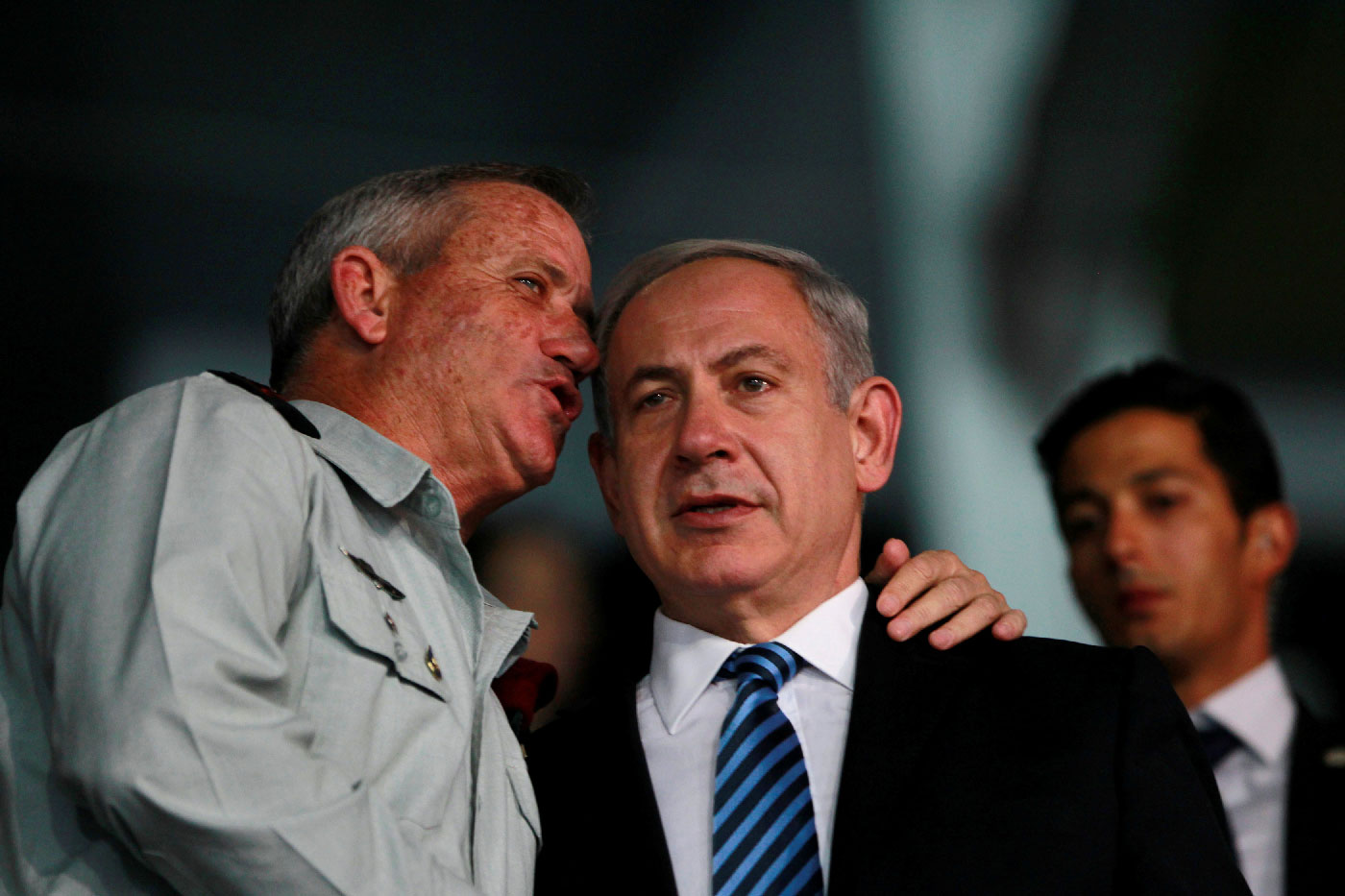 Israel's Prime Minister Benjamin Netanyahu (R) and Israel's armed forces chief Major-General Benny Gantz speak during the opening ceremony of the 19th Maccabiah Games at Teddy Stadium in occupied Jerusalem July 18, 2013.