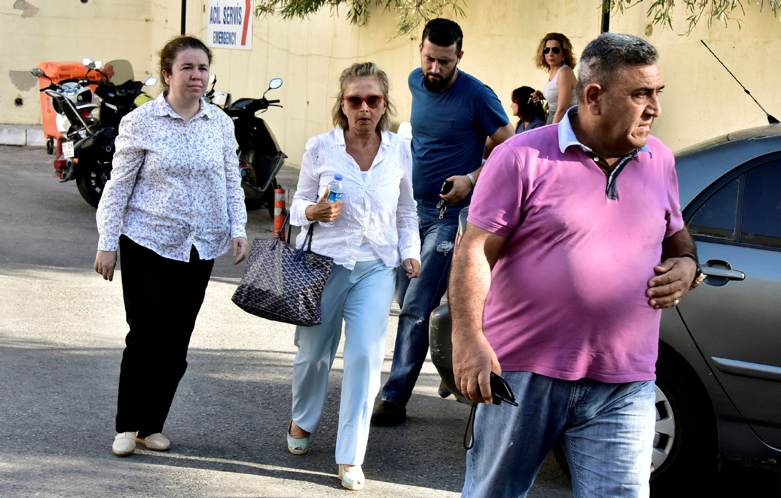 Turkish journalist Nazli Ilicak (C), also a well-known commentator and former parliamentarian, is escorted by a police officer (R) and her relatives (L and rear) after being detained and brought to a hospital for a medical check in Bodrum, Turkey, July 26, 2016.