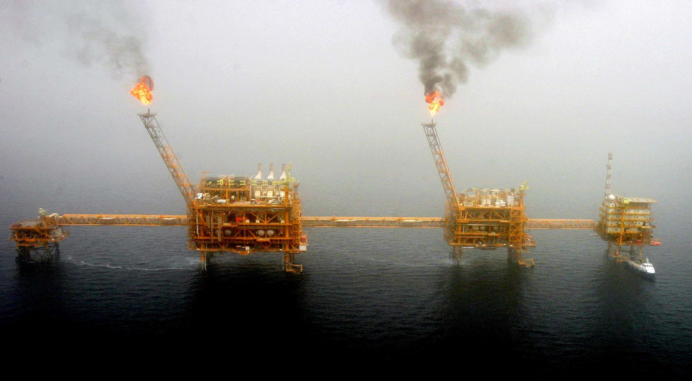Gas flares from an oil production platform at the Soroush oilfields in the Persian Gulf, south of the Iranian capital Tehran, July 25, 2005.