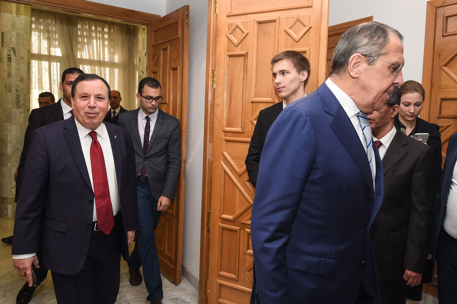 Tunisian Foreign Minister Khemaies Jhinaoui (L) arrives for a meeting with visiting Russian Foreign Minister Sergei Lavrov (R) in the capital Tunis on January 26, 2019.