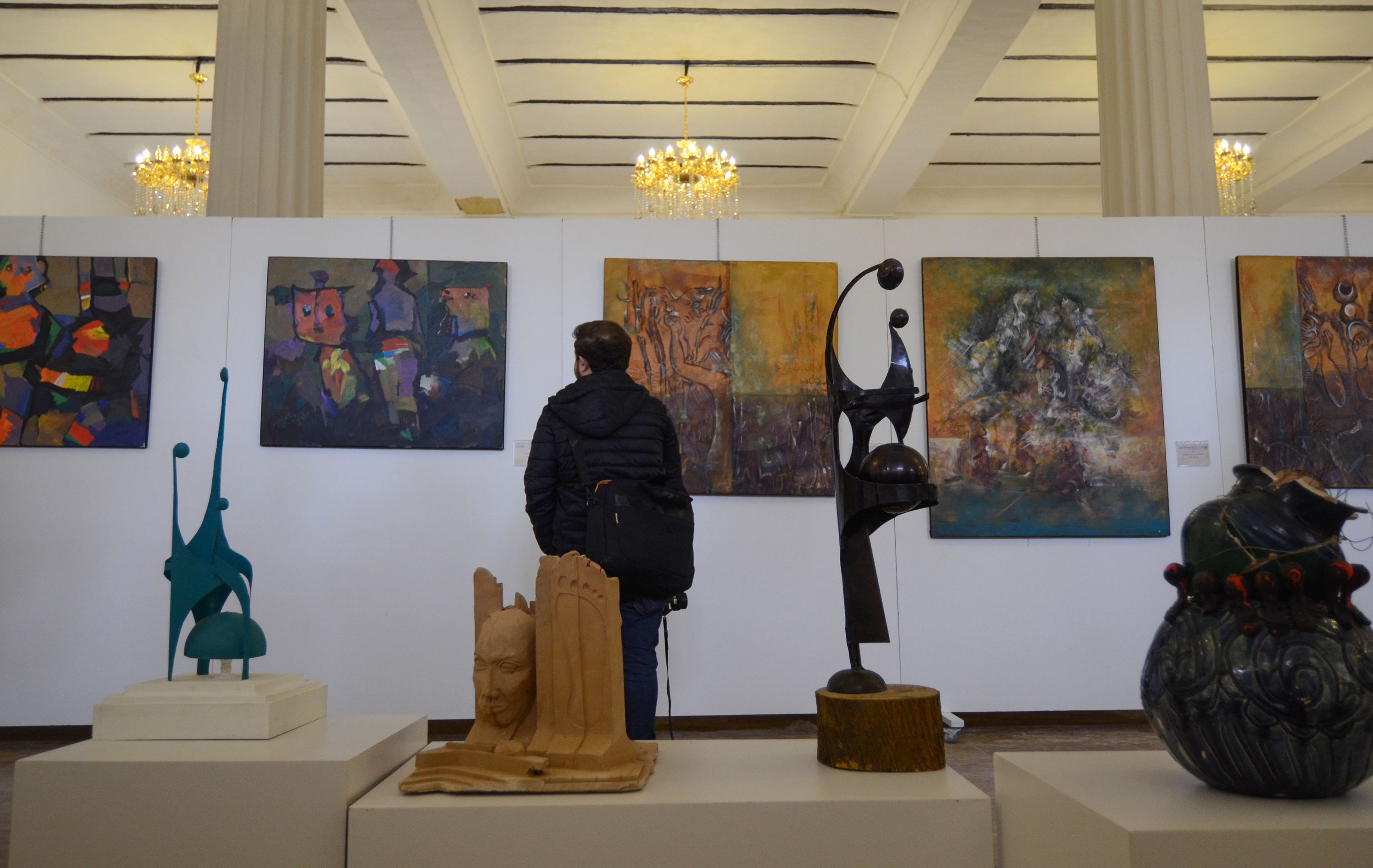An Iraqi man looks at paintings on January 29, 2019 at a contemporary art exhibition at one of the halls of the national museum of the northern Iraqi city of Mosul.
