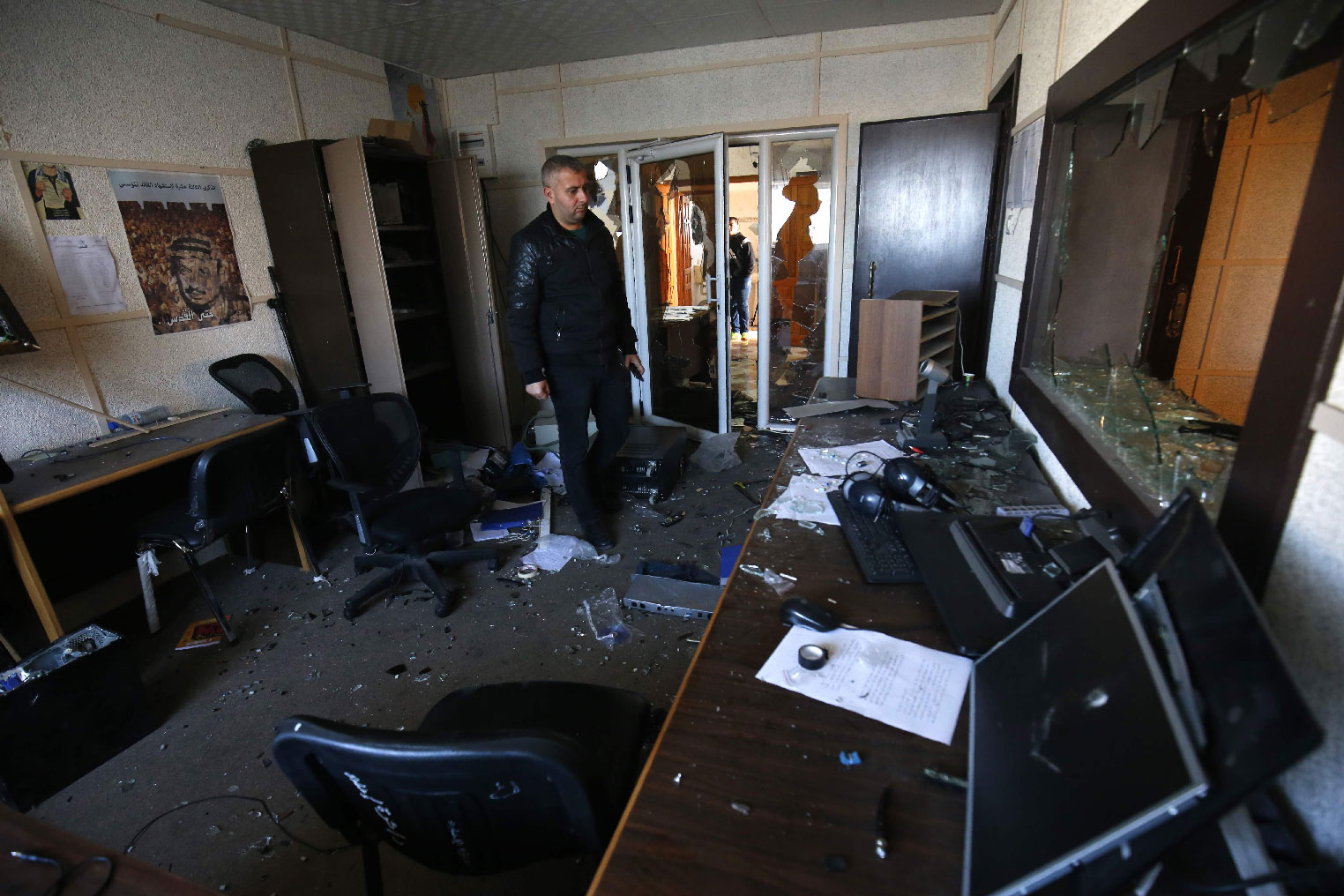 An employee of the Palestinian government-run radio and television stations inspects the damage at one of the studios on January 4, 2019, after armed men reportedly raided the building in Gaza City.