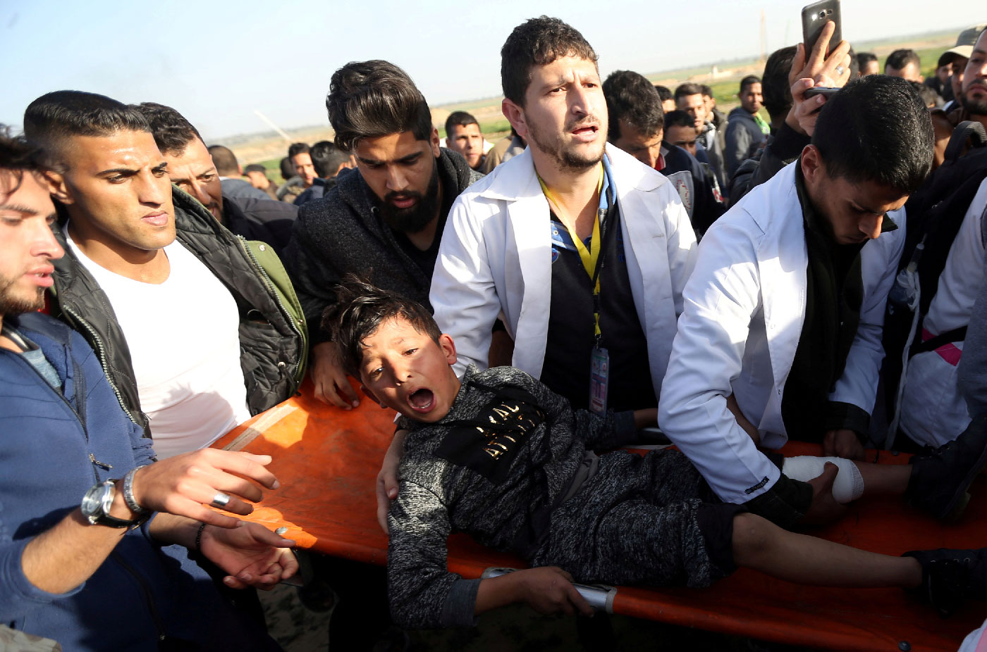 A wounded Palestinian boy reacts as he is evacuated during a protest at the Israel-Gaza fence, in the southern Gaza Strip January 25, 2019. 