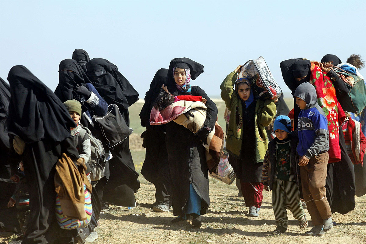 Women and children fleeing the battered Islamic State-held holdout of Baghouz