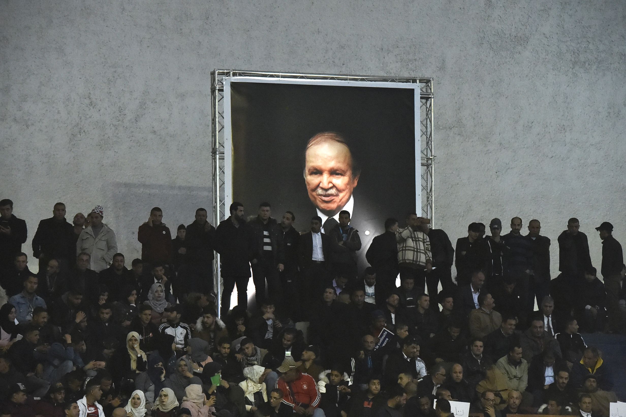 Supporters of Algferia's National Liberation Front (FLN) party, gather at La Coupole arena in the capital Algiers on February 9, 2019, to call upon the current President Abdelaziz Bouteflika (poster) to run for a fifth term in office.