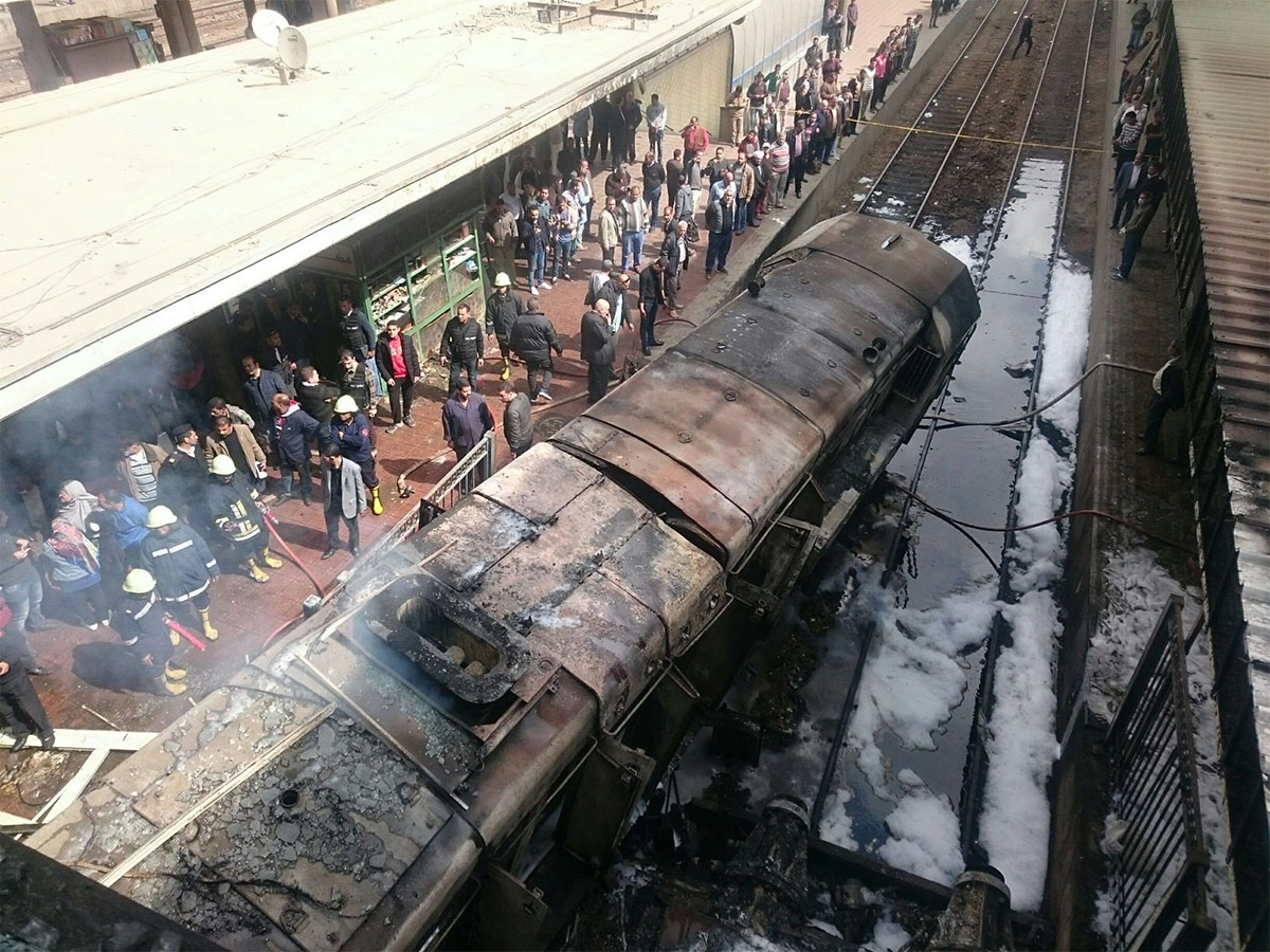 Burnt out wagons sit on the railway tracks after a fire caused deaths and injuries at the main train station in Cairo