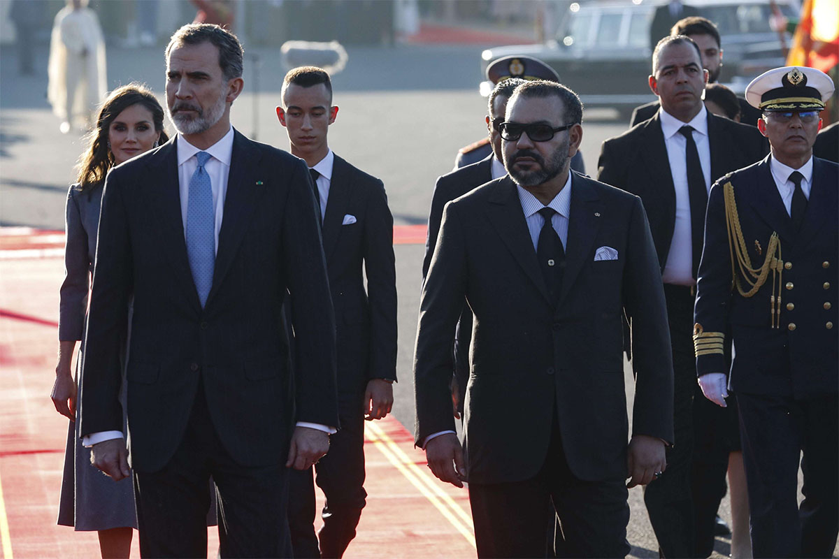 King Felipe VI (L) is greeted by Morocco's King Mohamed VI (R) upon his arrival at Rabat airport