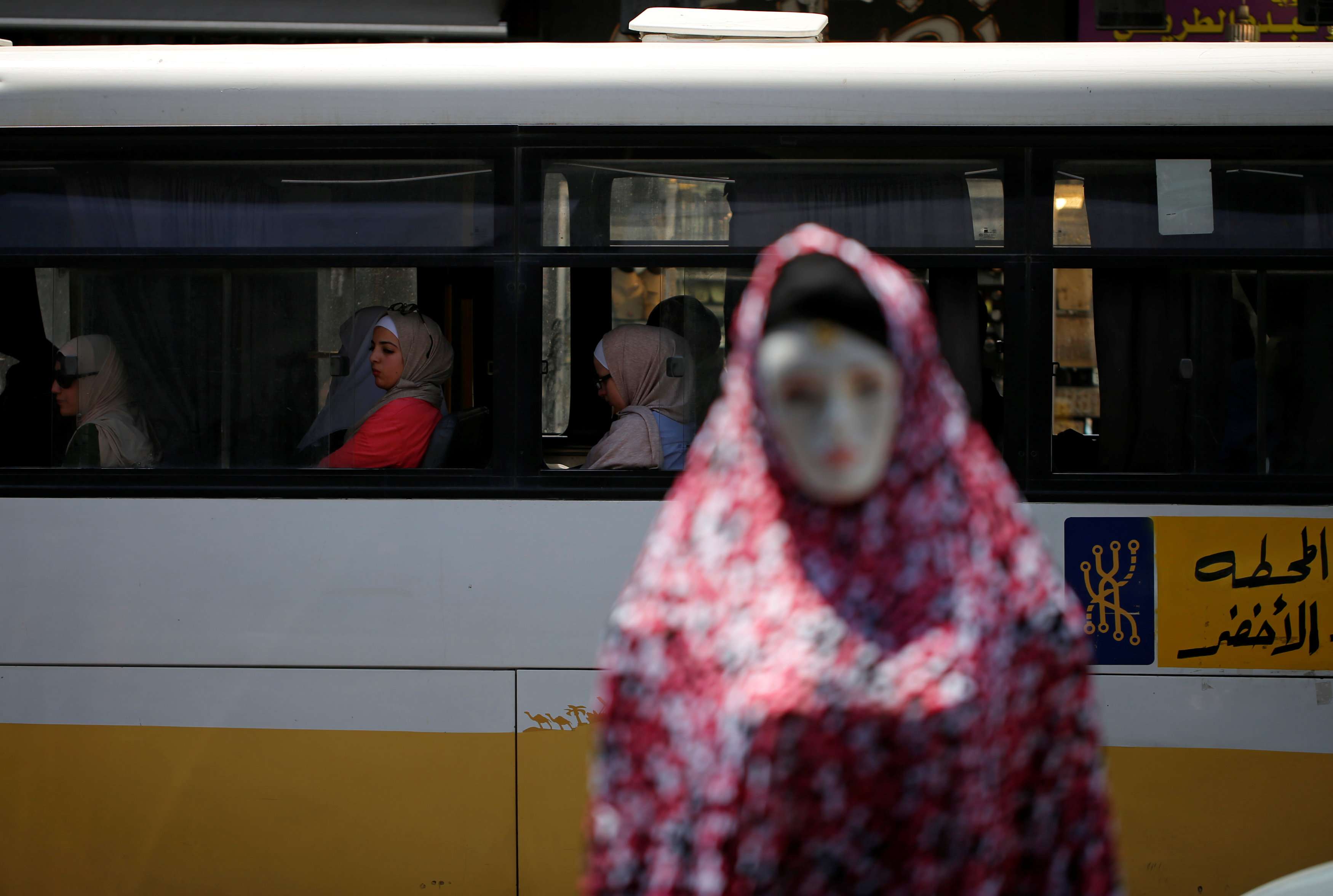 A mannequin is pictured as women ride a bus in Amman, Jordan June 6, 2018.