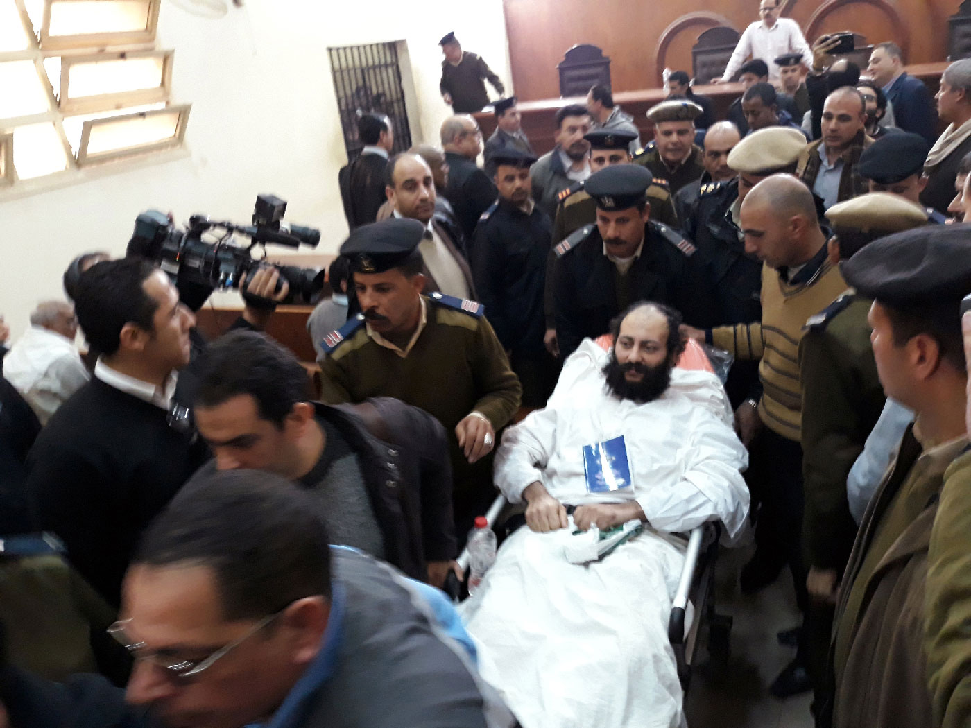 Ramon Rasmi Mansour, known as Faltaous al-Makari, lies on a stretcher after his and monk Isaiah's (not seen) trial session, at the courthouse in a courtroom where he was convicted along with Wael Saad, known as Isaiah al-Makari, of murdering Bishop Epiphanius, the abbot of Saint Macarius Monastery northwest of Cairo, in Damanhour, Egypt February 23, 2019.