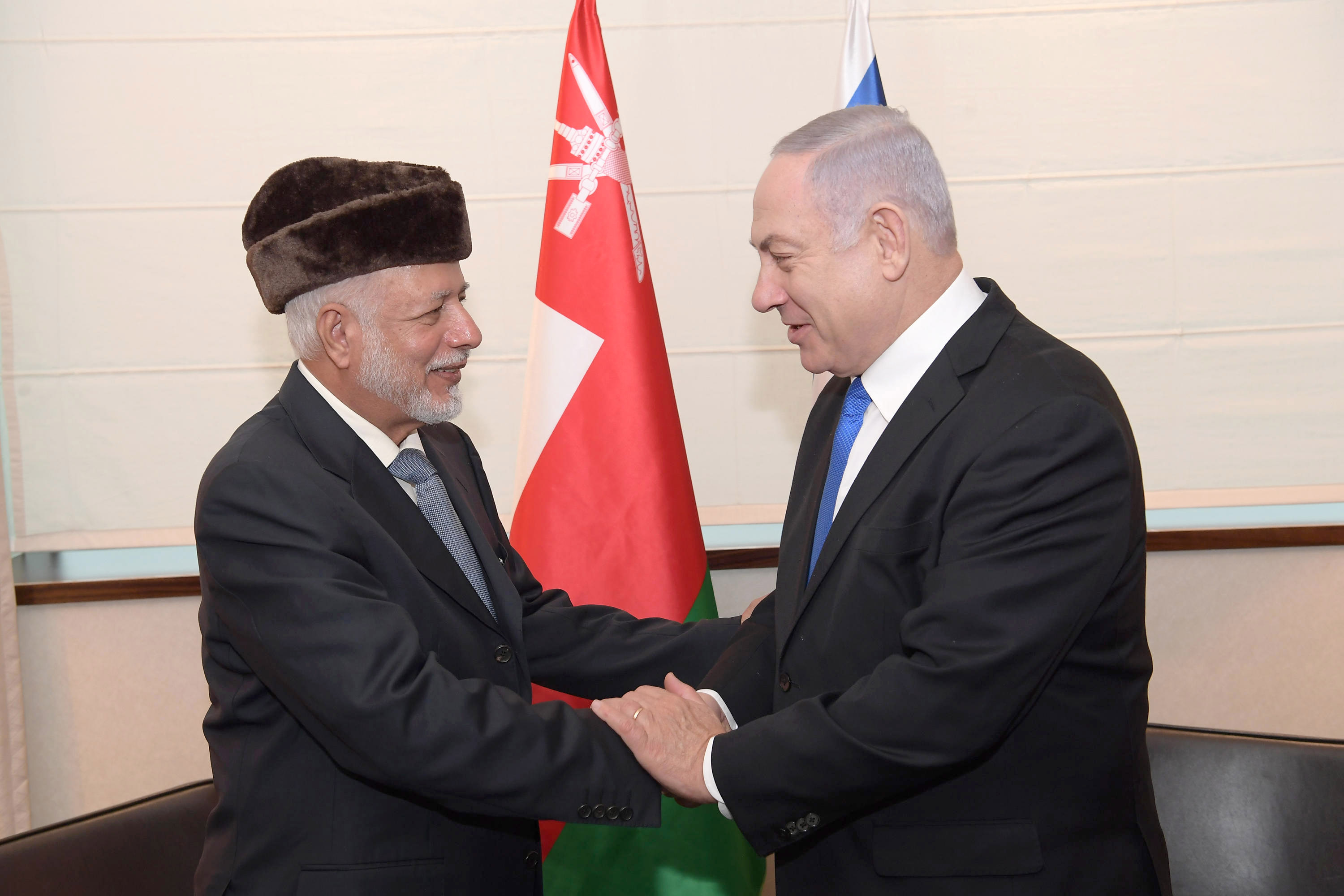 Israeli Prime Minister Benjamin Netanyahu (R) shakes hands with Minister of Foreign Affairs of Oman Yusuf bin Alawi during their meeting on the sidelines of the Warsaw Middle East Summit.