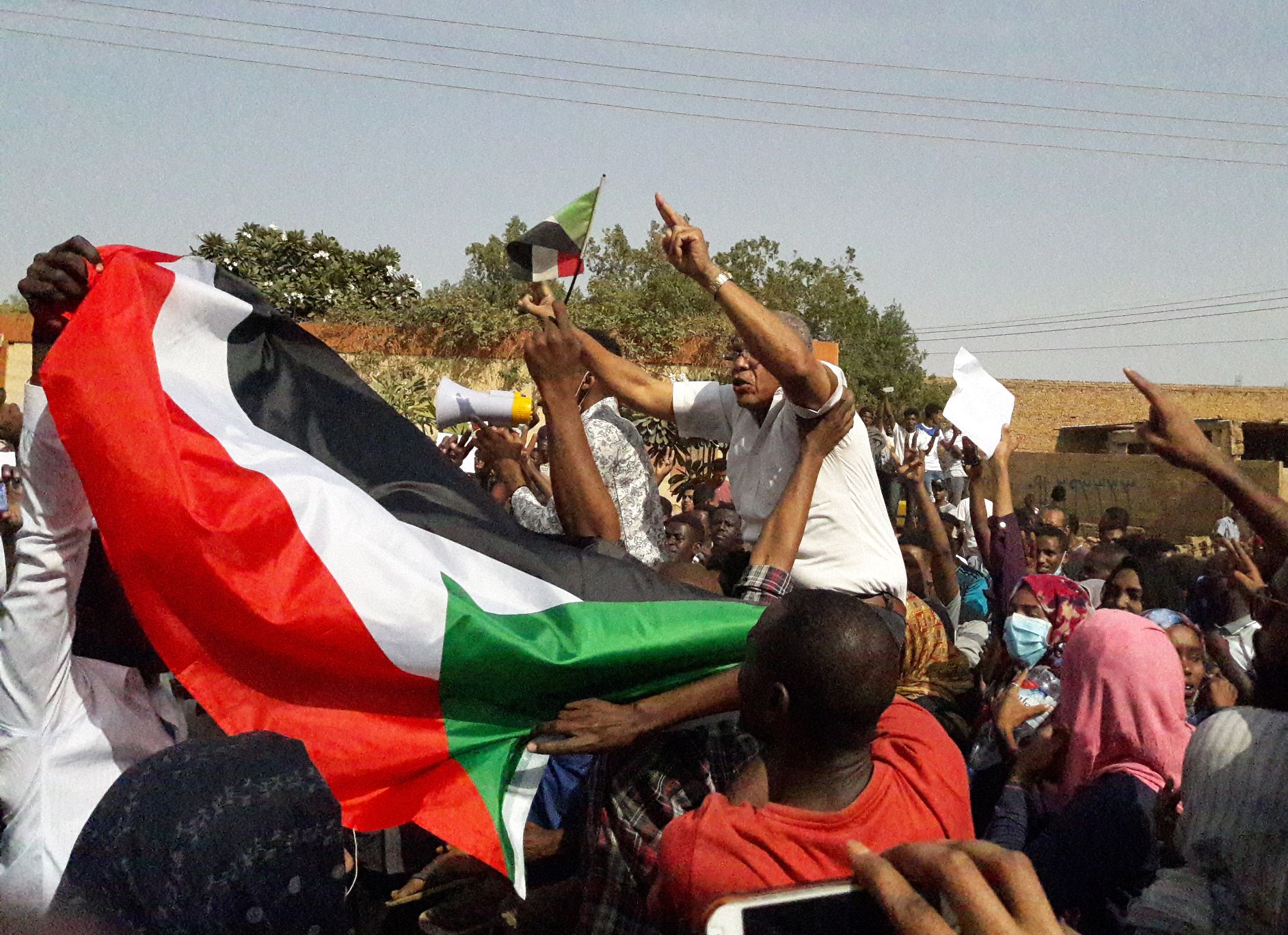 Sudanese protesters wave their national flag and chant slogans during an anti-government demonstration in the capital Khartoum's twin city of Omdurman on January 31, 2019.