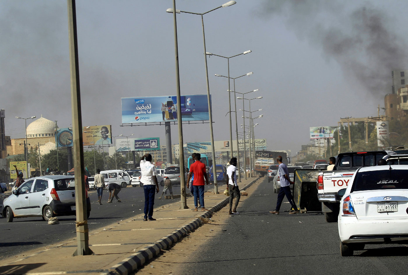 Cars block a road as Sudanese demonstrators stage anti-government protests in Khartoum, Sudan January 25, 2019. 