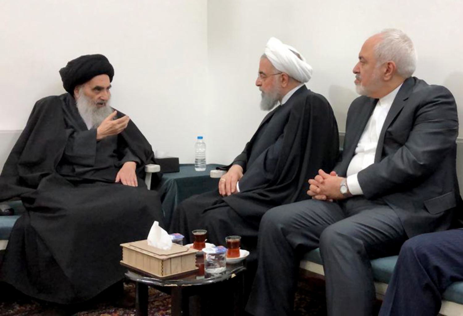 A handout picture provided by the media office of Grand Ayatollah Ali Sistani shows the chief Shiite cleric (L) meeting with Iranian President Hassan Rouhani (C) and Foreign Minister Mohammad Javad Zarif (R) in the Iraqi central city of Najaf on March 13, 2019.