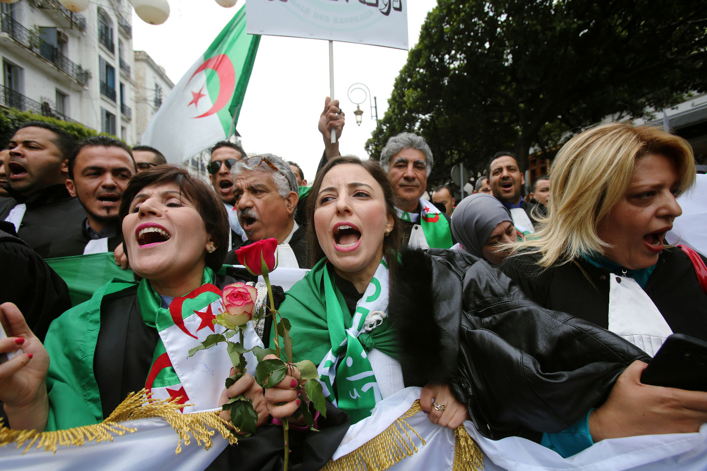 Lawyers carry national flags and flowers as they march during a protest to demand the immediate resignation of President Abdelaziz Bouteflika, in Algiers, Algeria March 23, 2019.