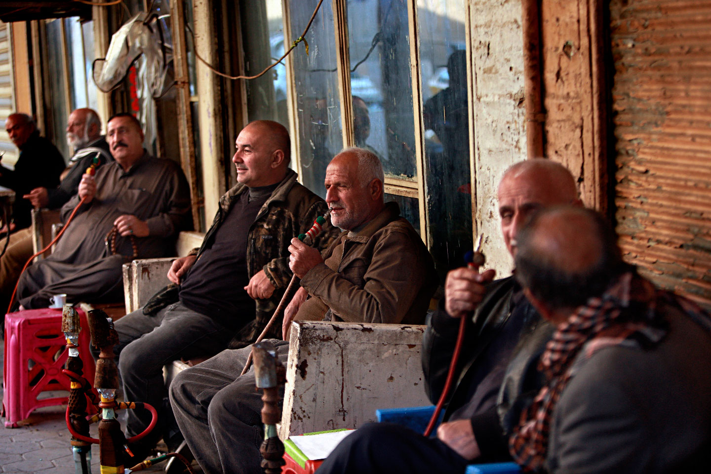 Patrons sit outside Hassan Ajami cafe in al-Rasheed street, the oldest street in Baghdad, Iraq, Saturday, March 2, 2019.