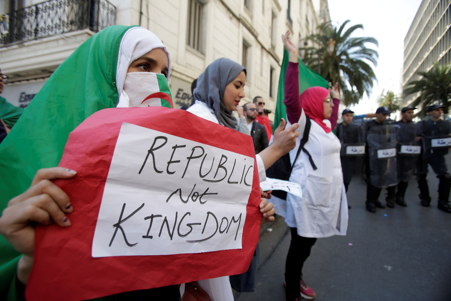 A demonstrator carries a sign as teachers and students take part in a protest demanding immediate political change in Algiers, Algeria March 13, 2019. 