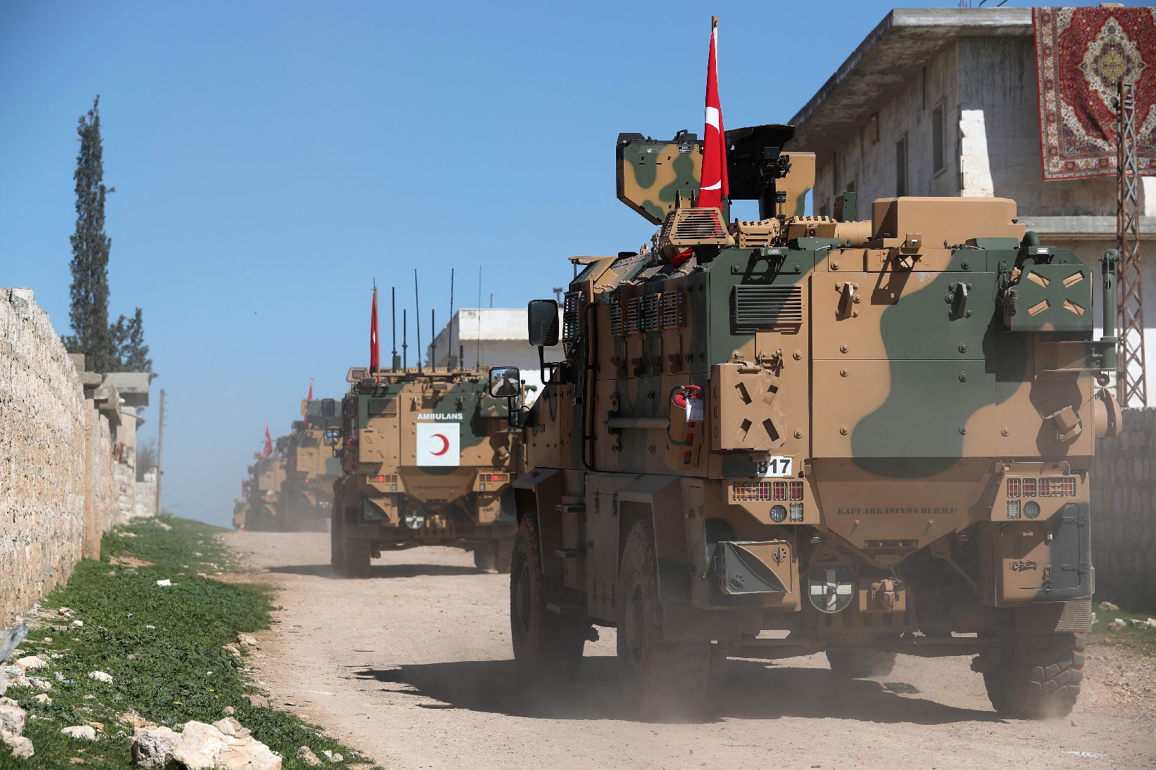A column of armoured Turkish military vehicles drives on a patrol along a road in the de-militarised zone in the western countryside of Syria's Aleppo province near the town of Al-Eis on March 8, 2019.