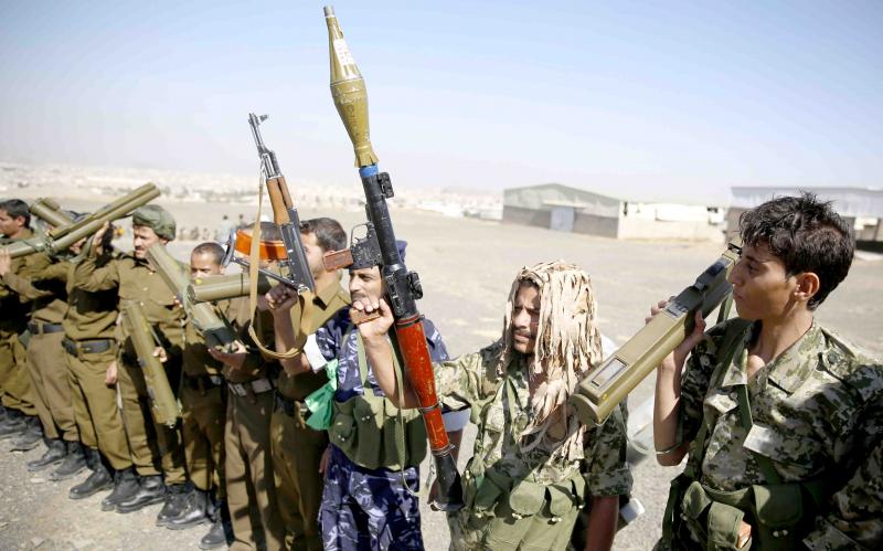 outhi fighters hold their weapons during a tribal gathering in Sana’a