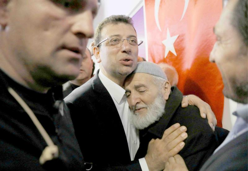 Ekrem Imamoglu, main opposition Republican People’s Party candidate for mayor of Istanbul, embraces a supporter in Istanbul, April 1