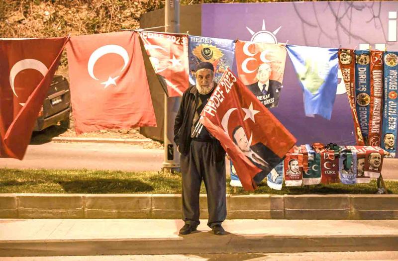 An AKP supporter stands near the headquarters of the party in Istanbul, March 31