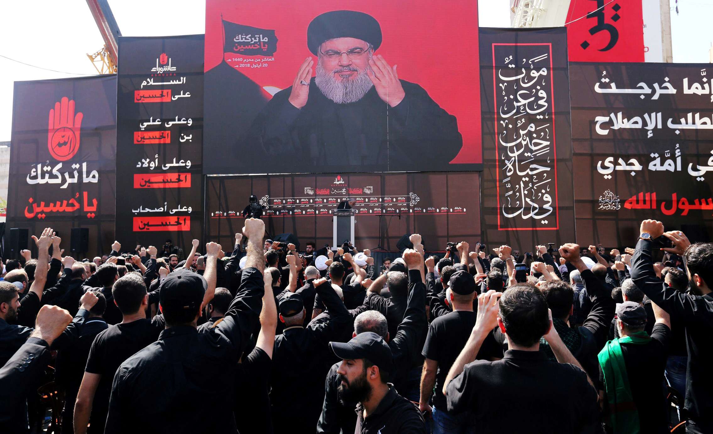 Hezbollah leader Sayyed Hassan Nasrallah addresses supporters via a screen in Beirut