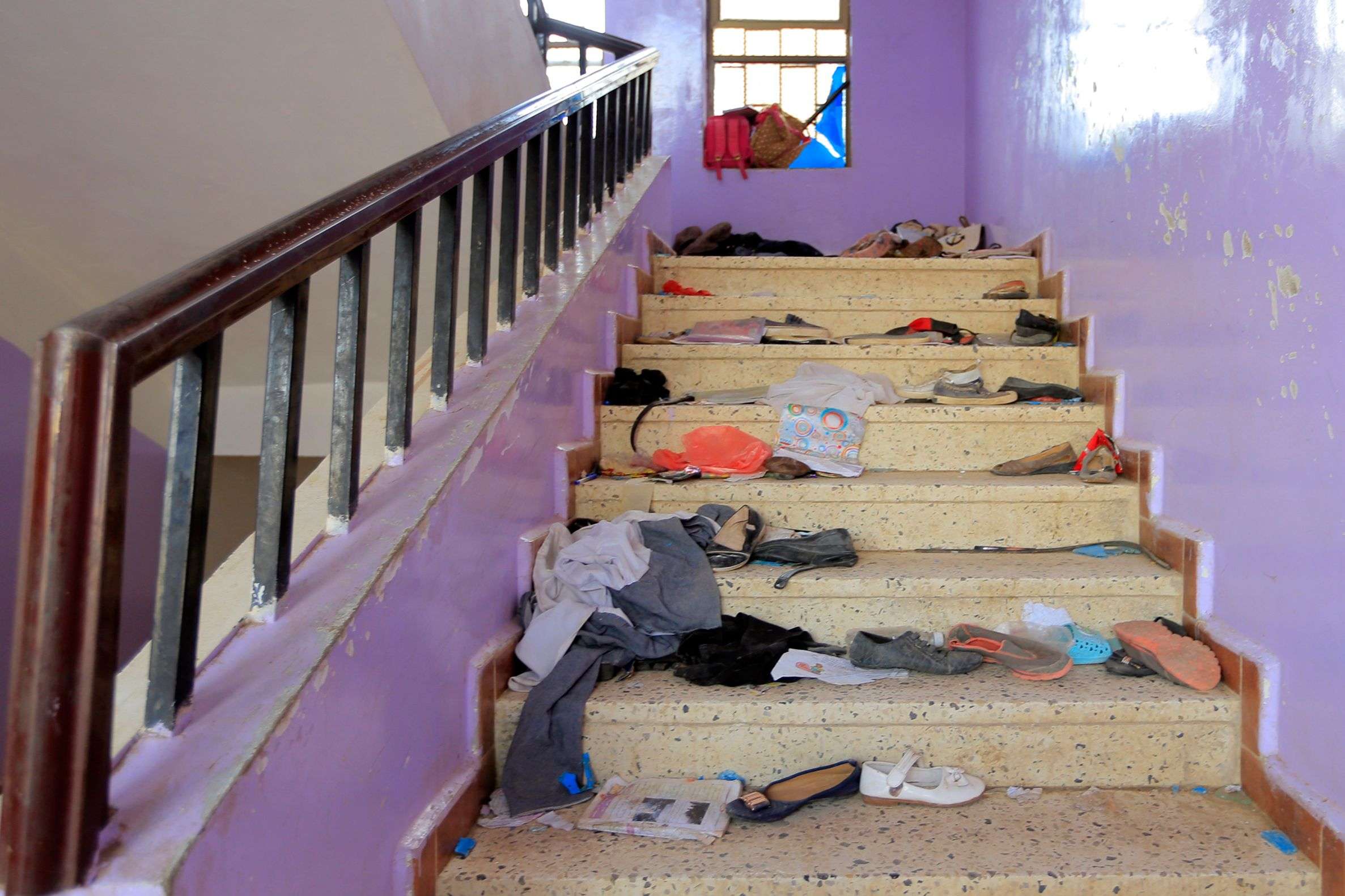 The belongings of Yemeni students are seen scattered on a staircase at a school in the capital Sanaa on April 7, 2019, following the deaths of 11 civilians including students in Yemen's capital.