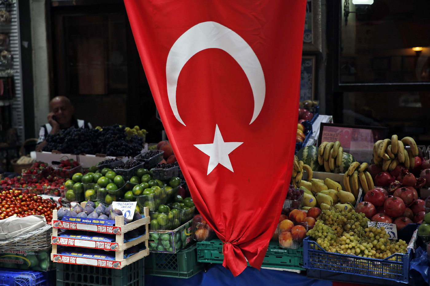 A shop owner waits for customers at a market in Istanbul