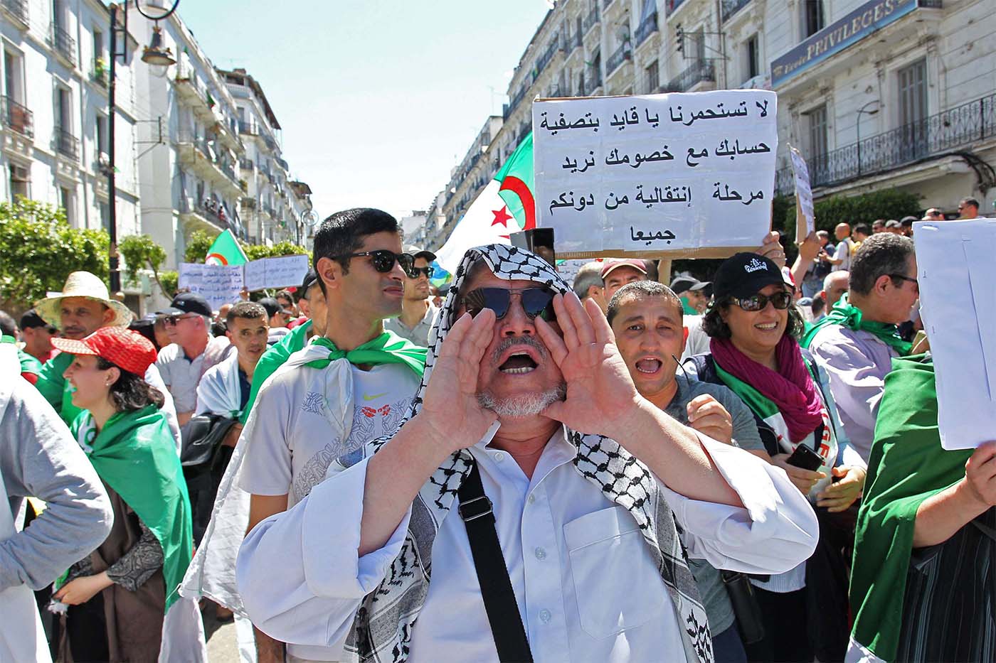 Algerian protesters chant slogans as they take part in an anti-government demonstration in Algiers 