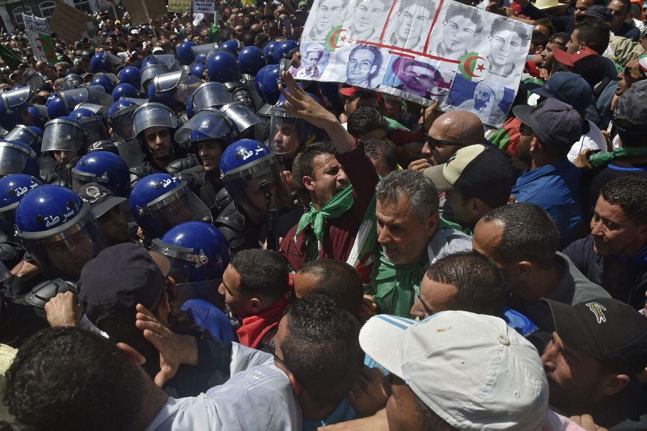 Algerian protesters chant slogans outside the central post office in Algiers