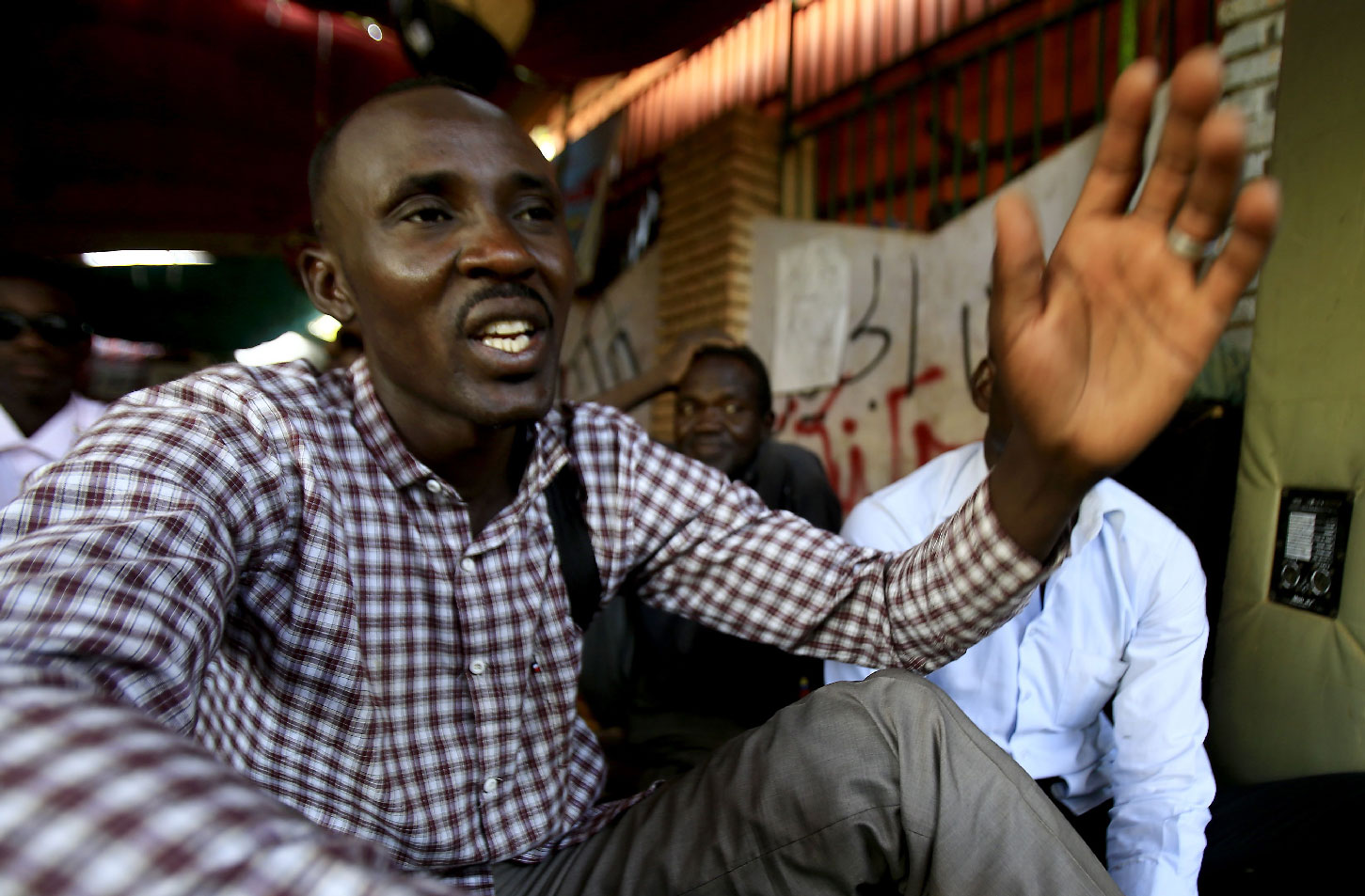 Sudanese man displaced from Darfur, Ahmed Idriss, speaks in a tent for Darfur refugees